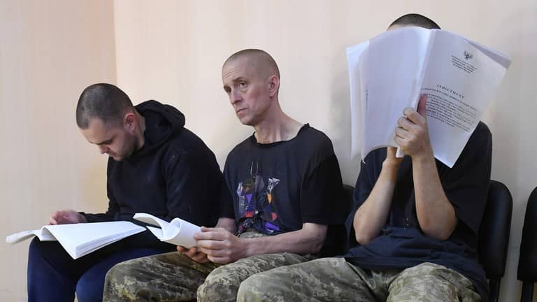 British citizens Aiden Aslin and Shaun Pinner and Moroccan citizen Saadun Ibrahim attend a court hearing in Donetsk Donetsk Peoples Republic